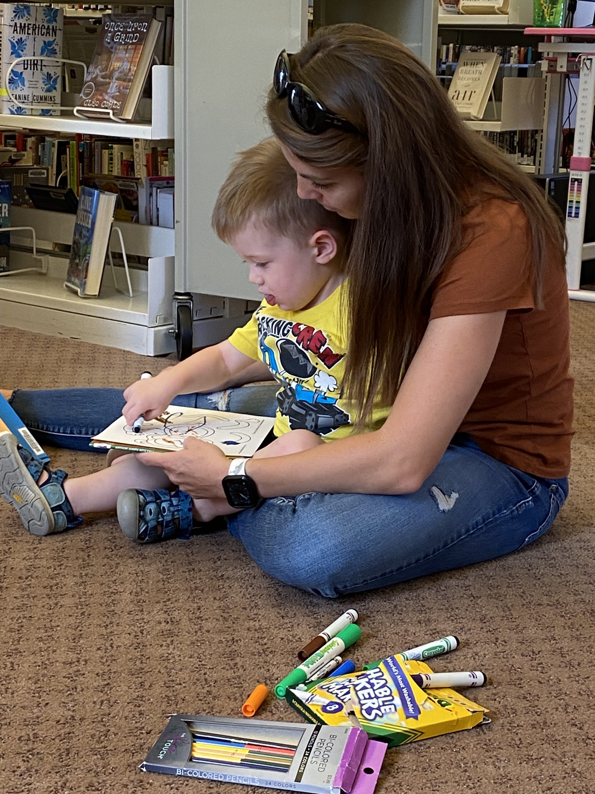 mom and son coloring at story time