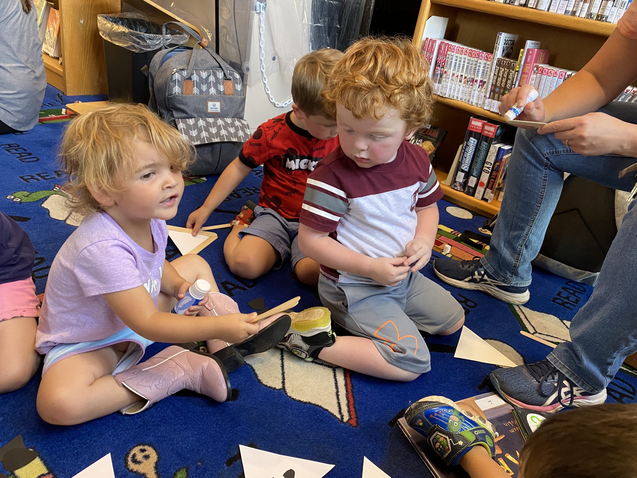 kids making a raccoon craft at story time